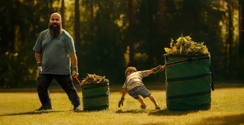 Francesco met twee volle tuinzakken op een zonnig gazon, terwijl een kleine helper aan een zak trekt